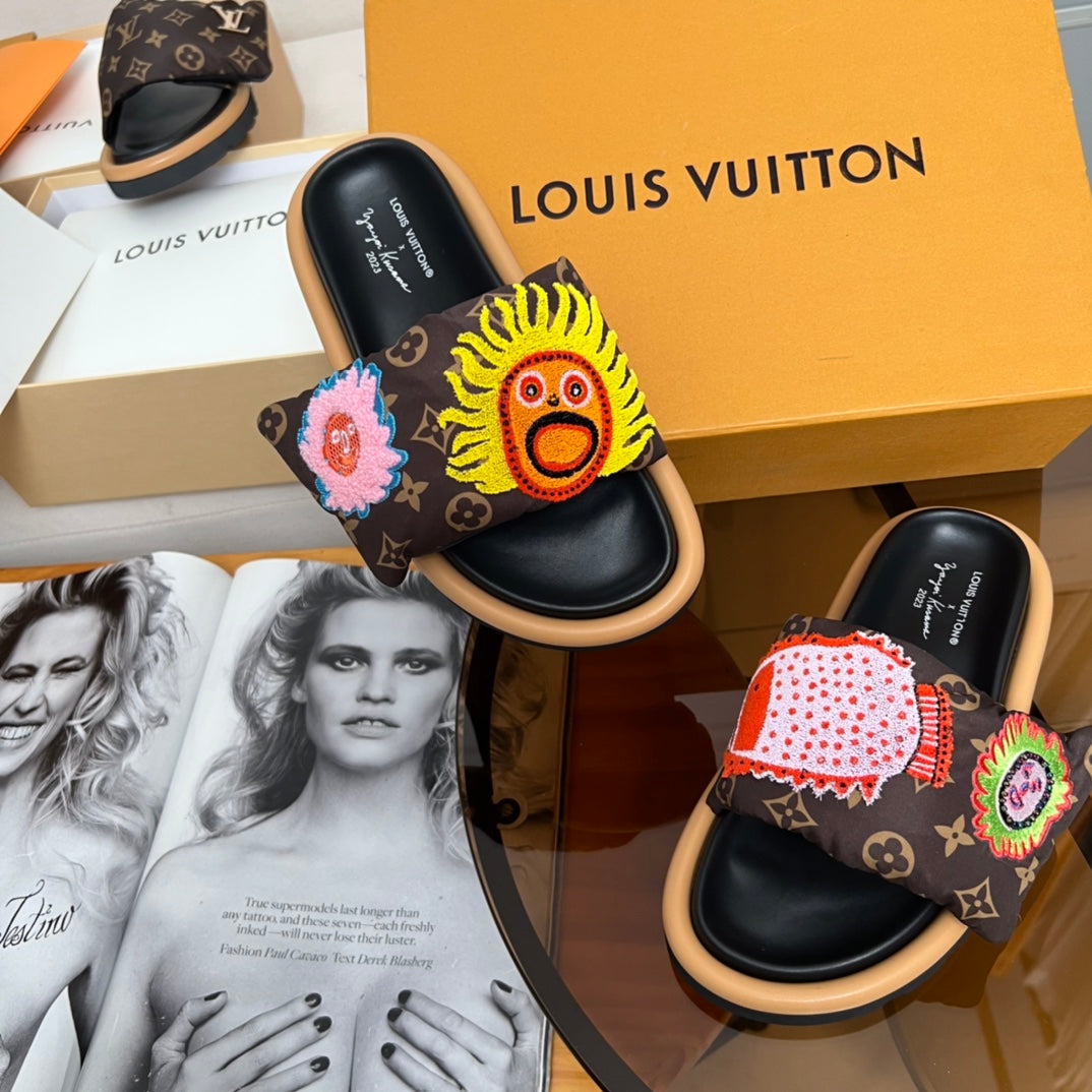 Louis Vuitton slide sandals with dark monogram straps and colorful yellow, pink, and red patches