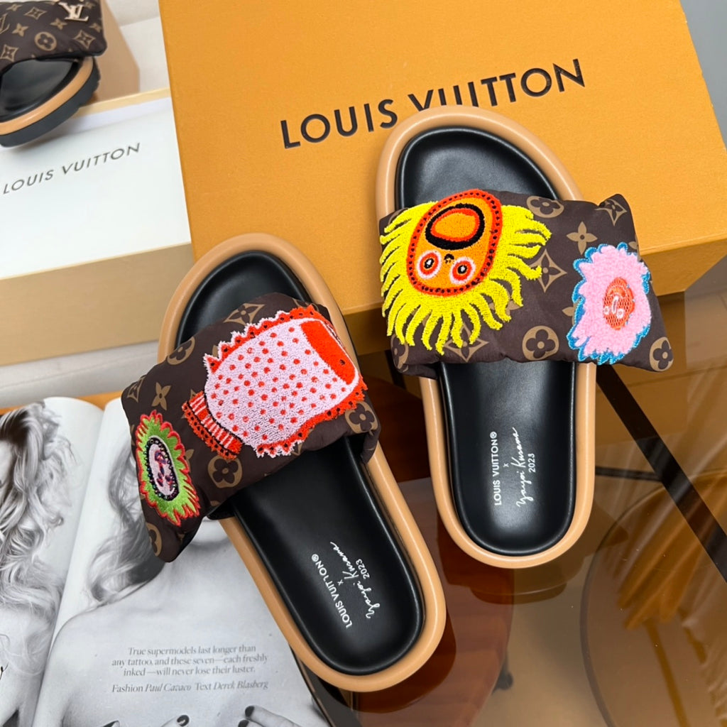 Louis Vuitton slide sandals with dark monogram uppers and embroidered lion and flower motifs