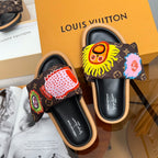 Louis Vuitton slide sandals with dark monogram uppers and embroidered lion and flower motifs