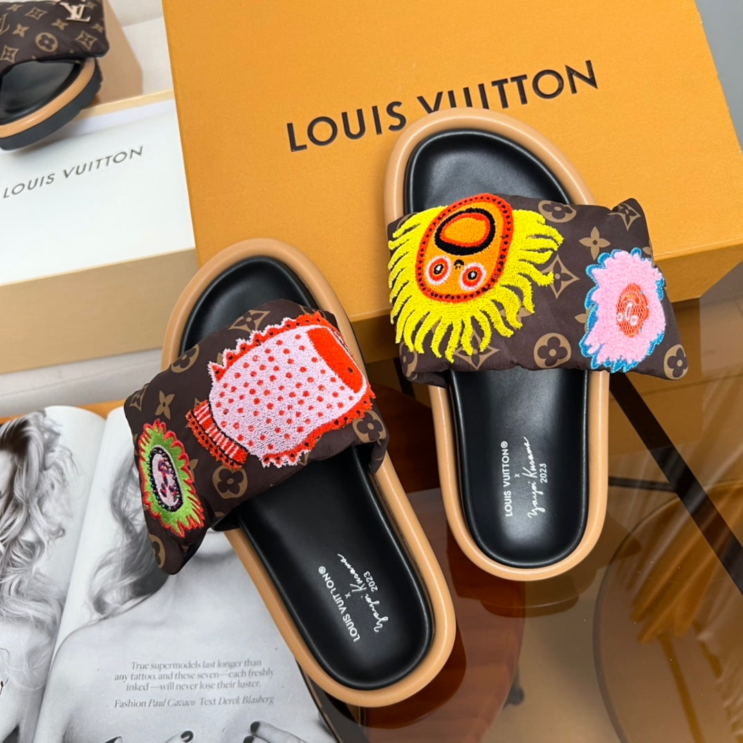 Louis Vuitton slide sandals with dark monogram uppers and embroidered lion and flower motifs