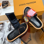 Louis Vuitton slide sandals with dark monogram straps and red flower and green emblem patch