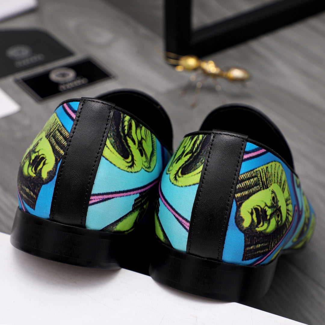 Versace printed loafers with black sole and side panels over blue yellow face print