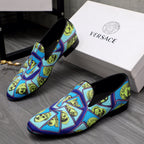 Versace printed slip-on shoes, blue upper with yellow face motifs, black topline