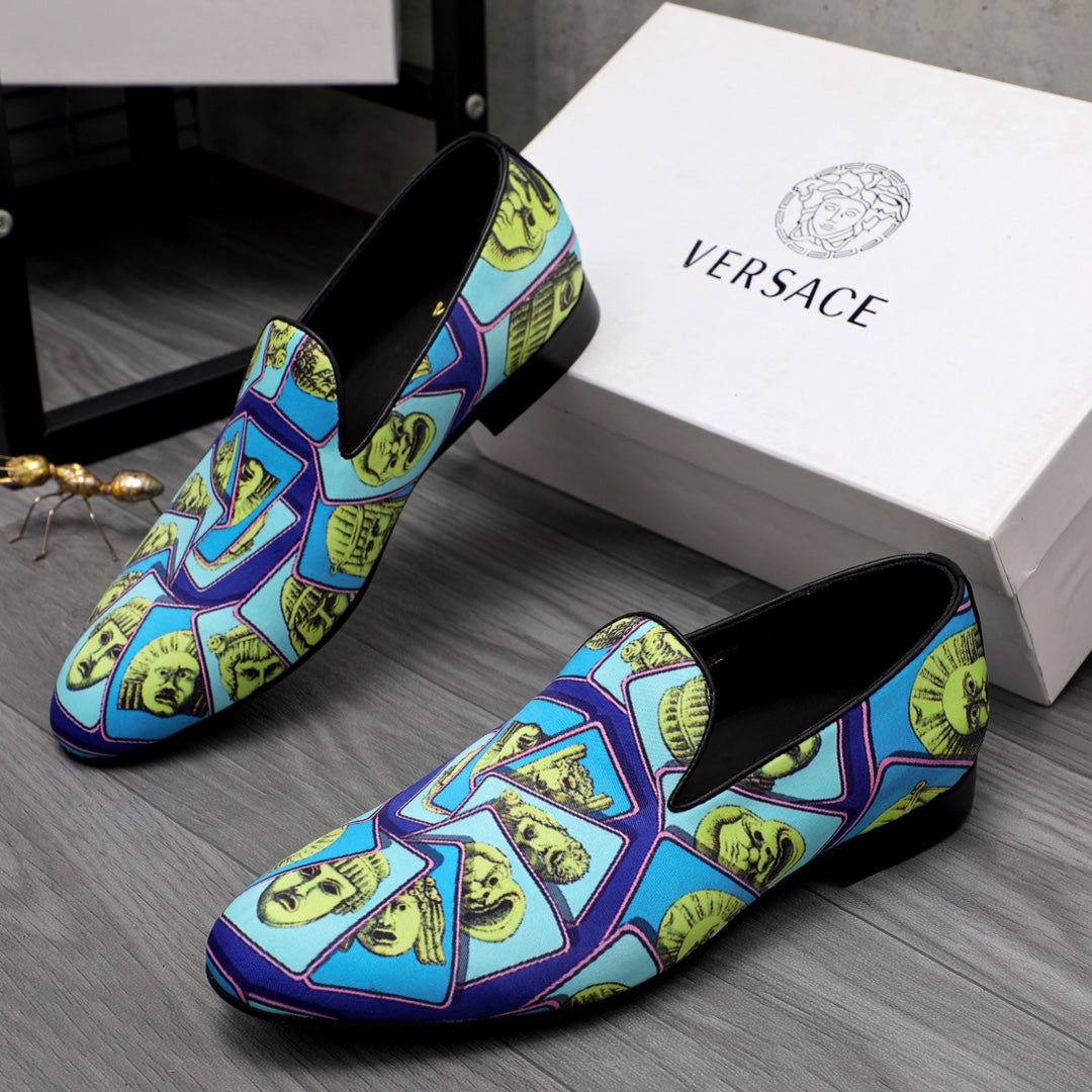 Versace printed slip-on shoes, blue upper with yellow face motifs, black topline