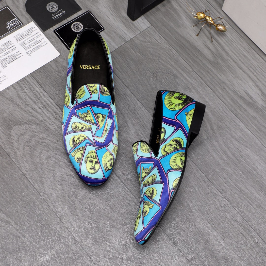 Versace printed slip-on shoes, blue upper with yellow face collage, black heels