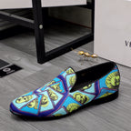 Versace printed slip-on loafer with blue upper, yellow face graphics, black insole