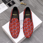 Versace luxury slip-on shoes, orange and blue geometric logo pattern, black trim