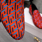 Versace luxury shoe upper, orange-blue geometric logo pattern