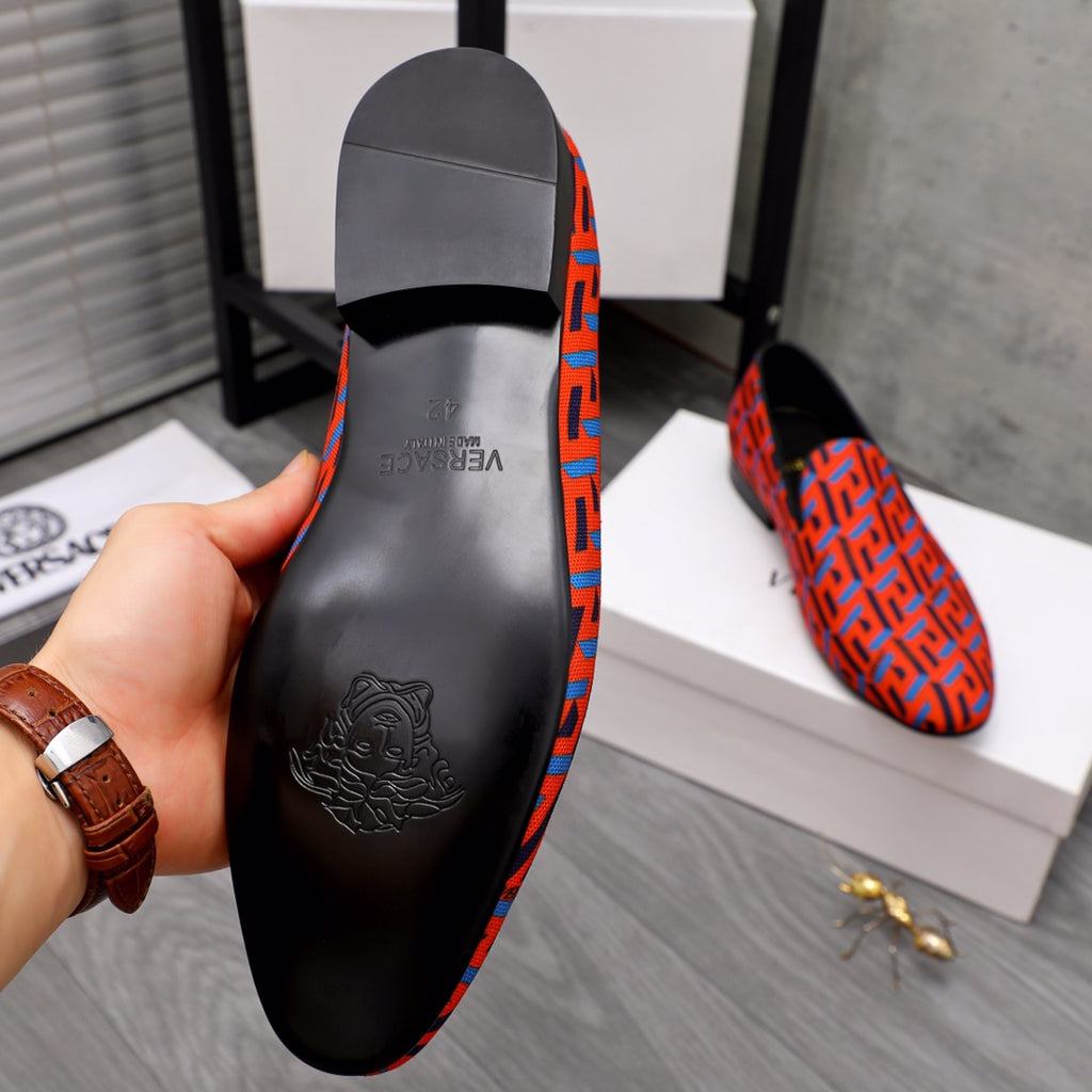 Versace luxury shoe insole, embossed logo on black with orange-blue patterned edge