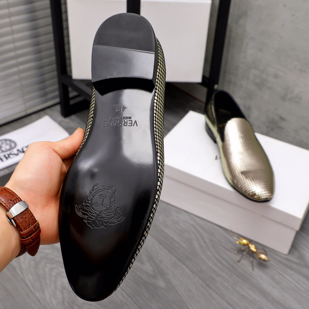 Rear view of rhinestone loafer with black heel panel and molded logo