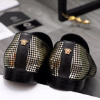 Back view of black and gold rhinestone loafers with medallion and chunky sole