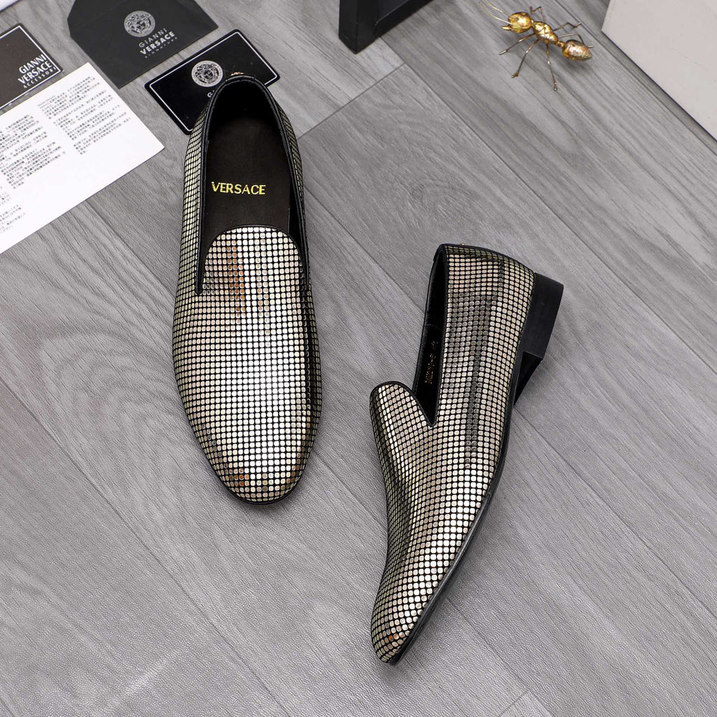 Gold and white rhinestone slip-on loafers with black uppers and pointed toe