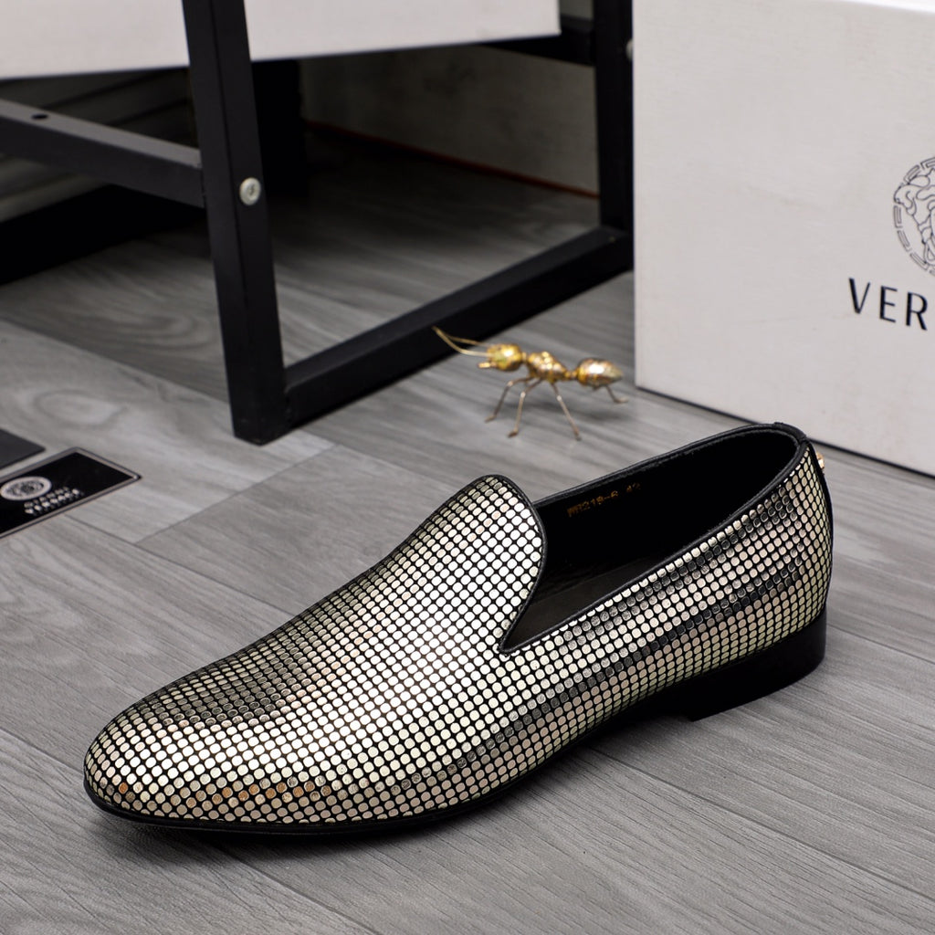 Gold and white rhinestone slip-on loafers with curved toe and black sole trim