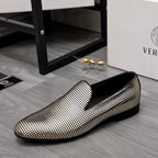Gold and white rhinestone slip-on loafers with curved toe and black sole trim