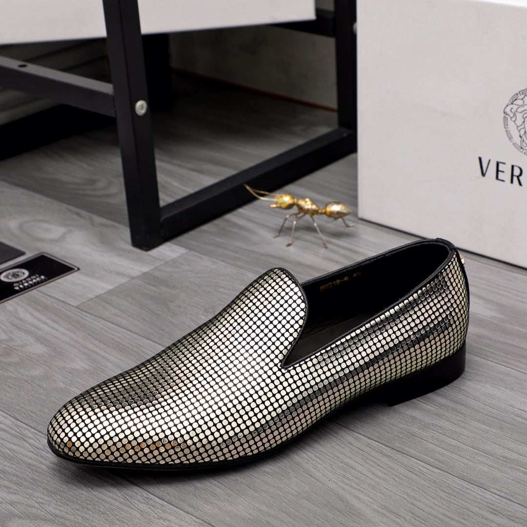Gold and white rhinestone slip-on loafers with curved toe and black sole trim