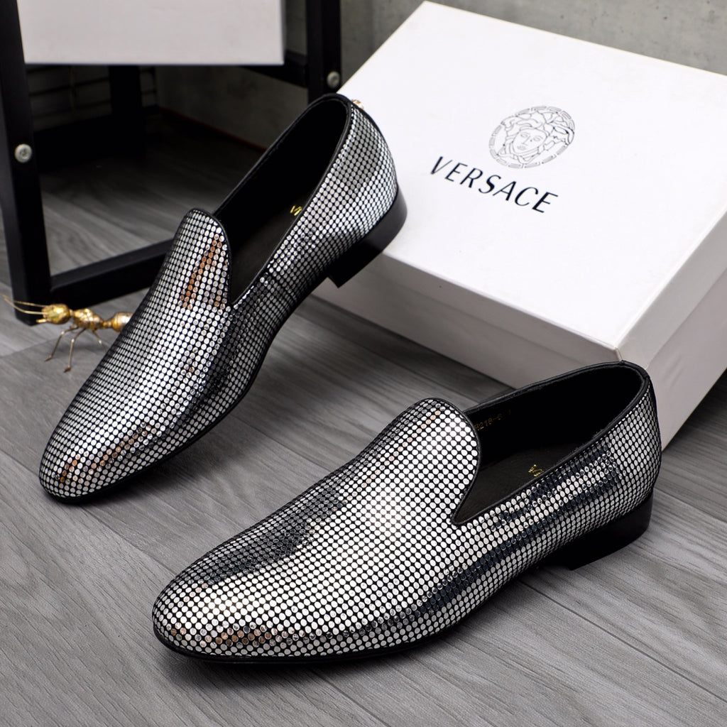 Pair of rhinestone loafers with black heels and pointed toes, gold accent on vamp
