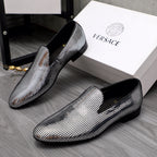 Pair of rhinestone loafers with black heels and pointed toes, gold accent on vamp