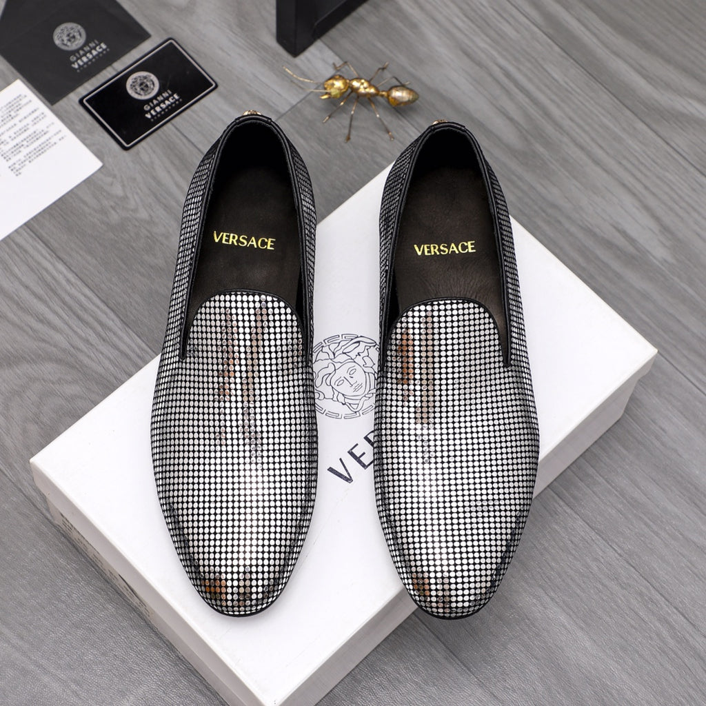 Rhinestone slip-on loafers with black uppers and pointed toe, gold emblem detail