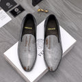 Rhinestone slip-on loafers with black uppers and pointed toe, gold emblem detail