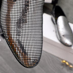 Close-up rhinestone mesh upper on a black pointed loafer