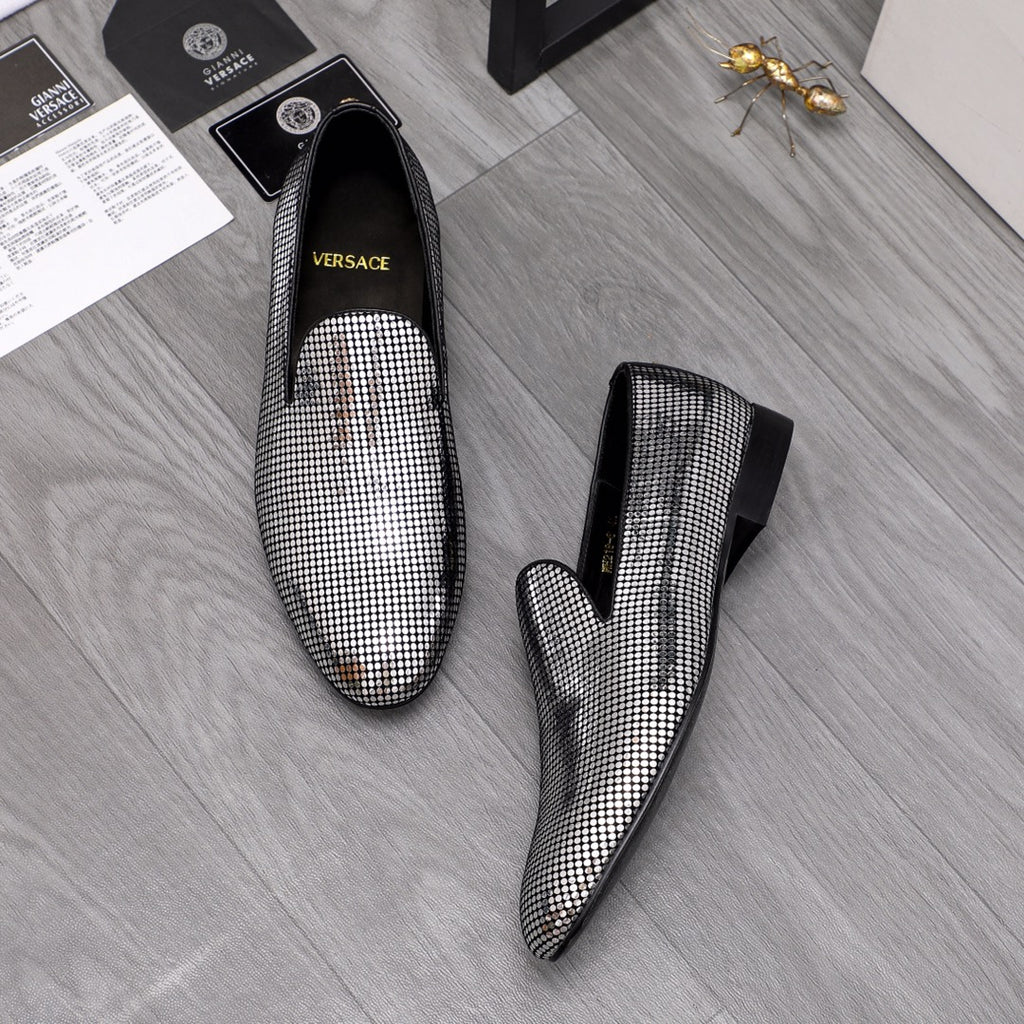 Pair of rhinestone loafers with black sides and pointed toes, slip-on style