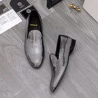 Pair of rhinestone loafers with black sides and pointed toes, slip-on style