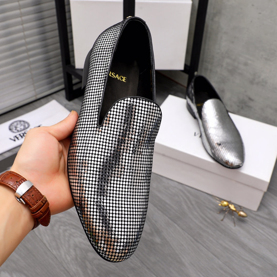Rhinestone slip-on loafer with pointed toe and black lining, gold logo patch