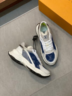 White and blue monogram unisex sneakers pair with lace-up fronts