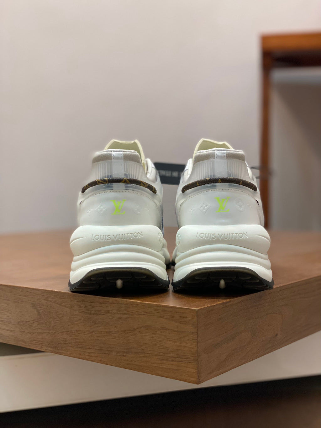 White unisex sneakers pair with lime logo accents and chunky heel