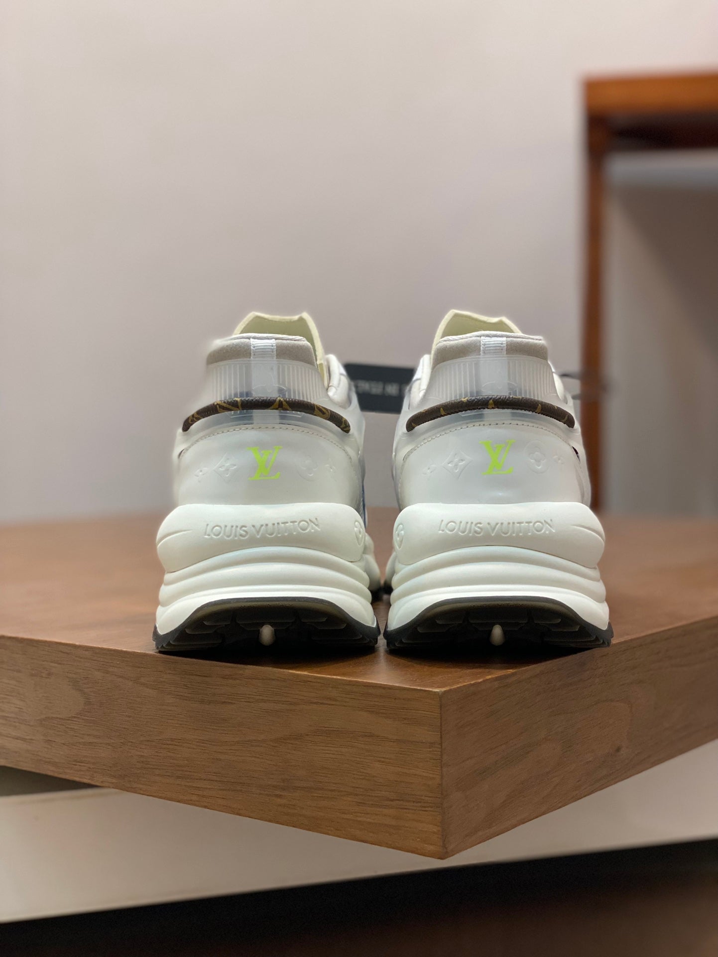 White unisex sneakers pair with lime logo accents and chunky heel