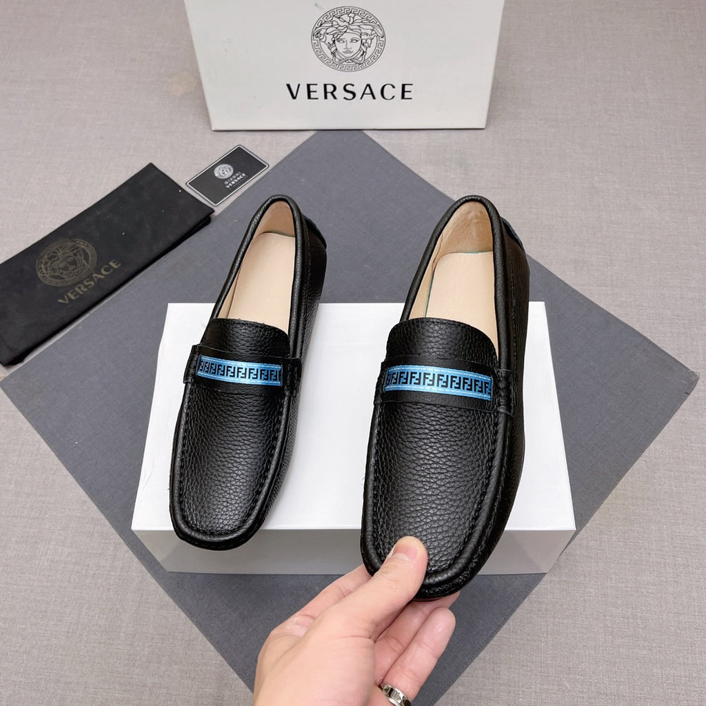 Black leather loafers with blue logo band, front profile, beige insole