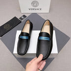 Black leather loafers with blue logo band, front profile, beige insole