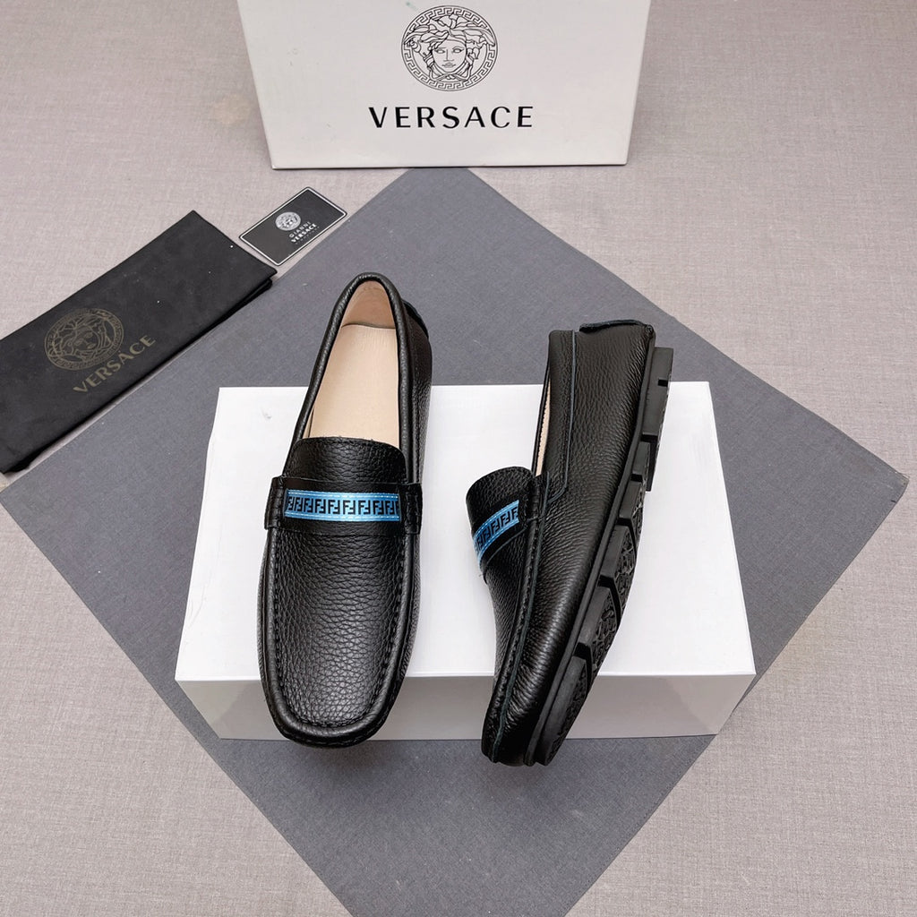 Black leather loafers with blue logo band and rubber sole, side view