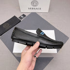 Black leather loafer with blue logo band, side profile and textured rubber sole