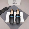 Black leather loafers with blue logo band, slip-on design, beige interior