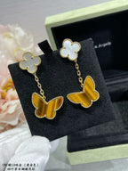 Van Cleef & Arpels dangling earrings with white clover and yellow butterfly charms
