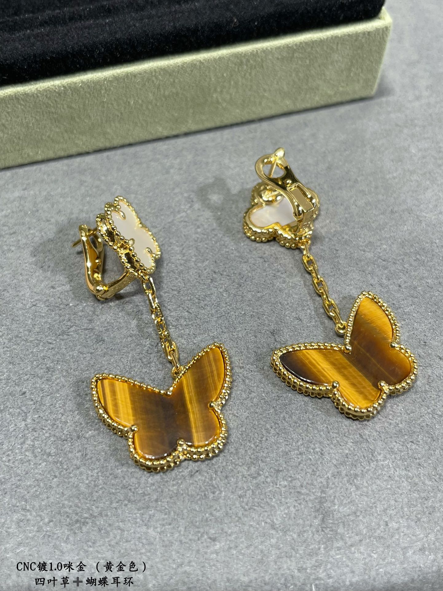 Van Cleef & Arpels drop earrings with white clover caps and yellow butterfly charms