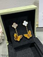 Van Cleef & Arpels clover and butterfly drop earrings, white and gold with yellow charms