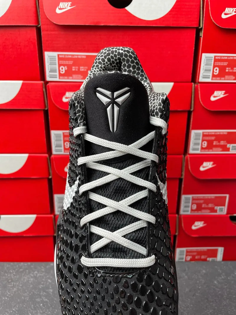 Black Nike basketball shoe front view with laces, textured upper, and winged logo
