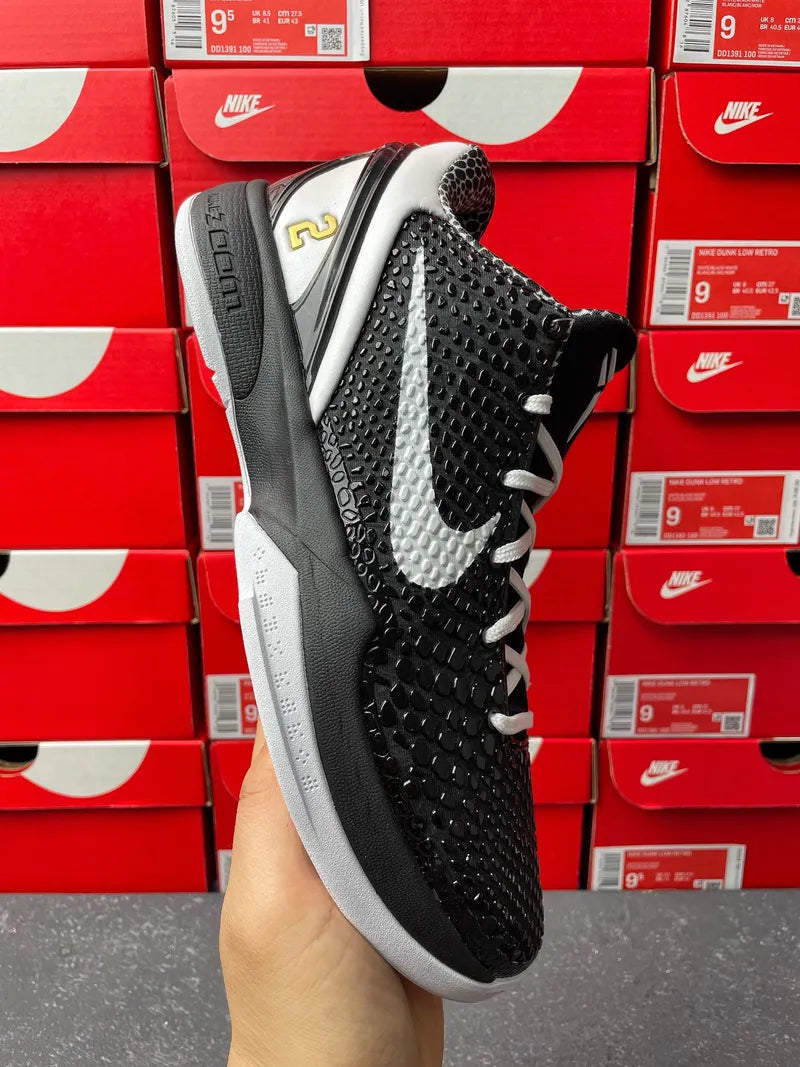 Nike basketball shoe 3/4 angle showing black upper and white swoosh