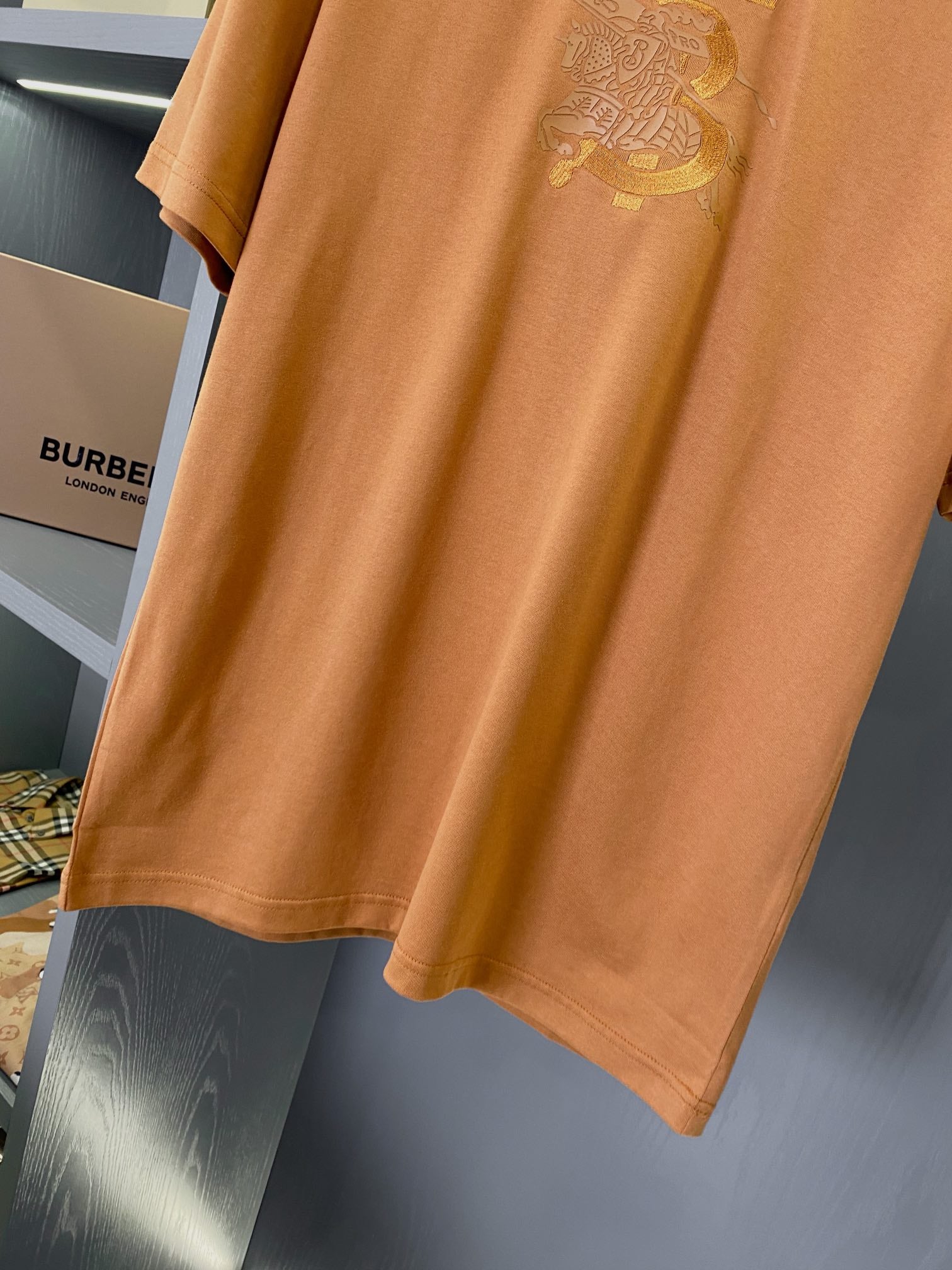 Burberry short-sleeve T-shirt, rust orange, straight hem and side drape