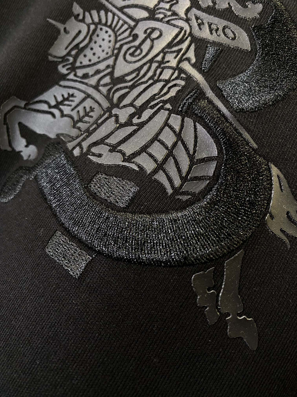 Black Burberry T-shirt close-up of front emblem graphic with textured outline