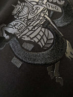 Black Burberry T-shirt close-up of front emblem graphic with textured outline