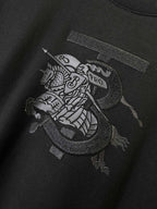 Black Burberry T-shirt with dark front graphic patch on the chest