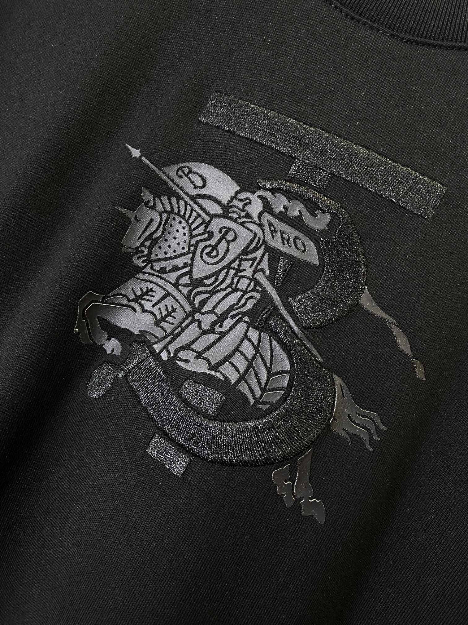 Black Burberry T-shirt with dark front graphic patch on the chest