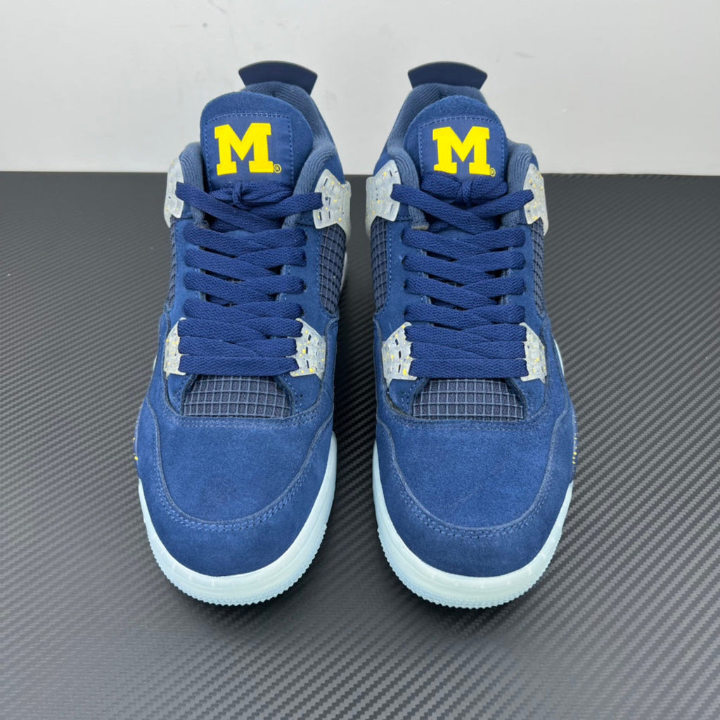 Air Jordan 4 sneaker pair with blue laces, white midsoles, and yellow “M” patches