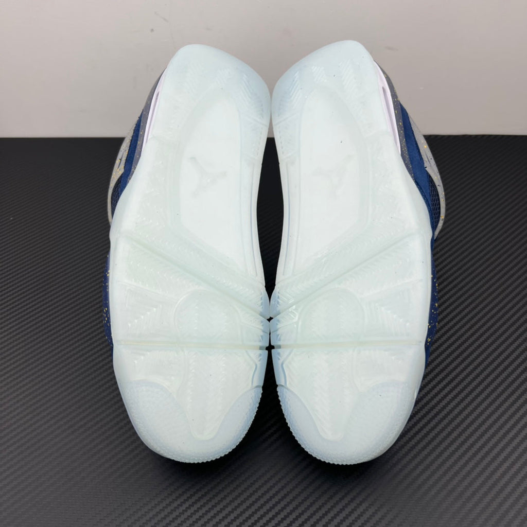 Air Jordan 4 sneaker outsole with white tread panels and blue edge trim