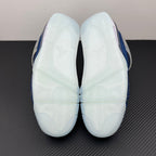 Air Jordan 4 sneaker outsole with white tread panels and blue edge trim