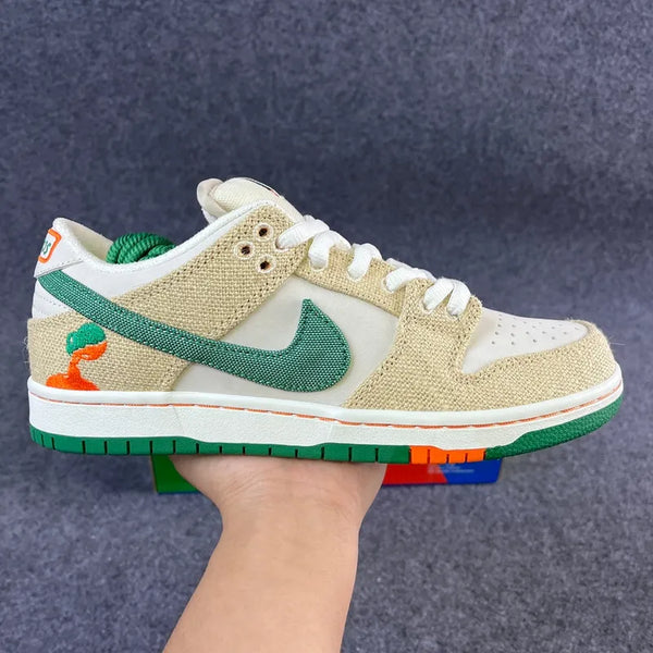 Low-top sneakers with beige canvas upper, white panels, and green swoosh