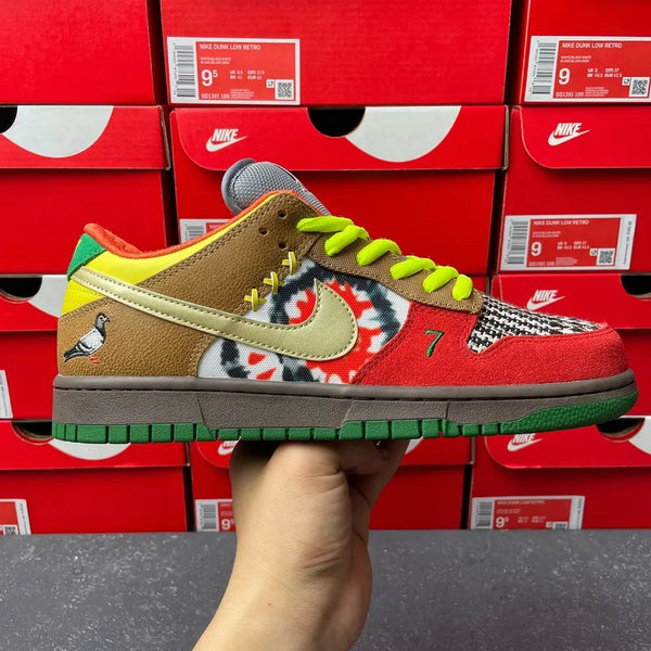 Nike SB low-top sneaker in tan and red with multicolor graphics and neon green laces